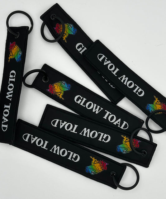 GLOW TOAD FLIGHT TAG KEYCHAIN: CARRY THE GLOW