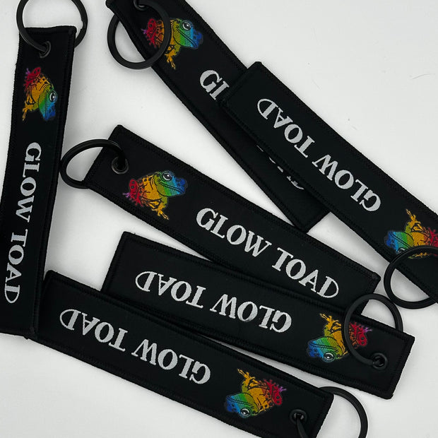 GLOW TOAD FLIGHT TAG KEYCHAIN: CARRY THE GLOW